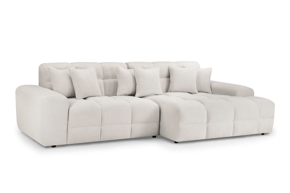 Large cream corner sofa with deep seats, tufted back cushions, and matching throw pillows