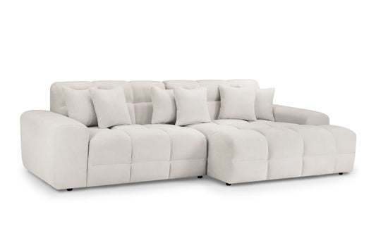 Large cream corner sofa with deep seats, tufted back cushions, and matching throw pillows
