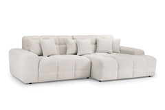 Large cream corner sofa with deep seats, tufted back cushions, and matching throw pillows