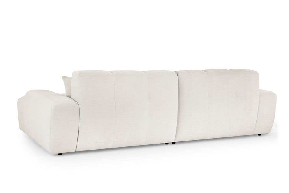 Rear view of the cream corner sofa with a low, upholstered back
