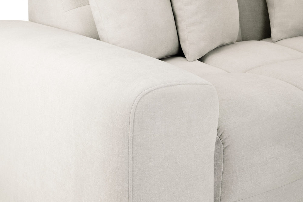 Large corner sofa with a rounded upholstered arm and deep seat cushions