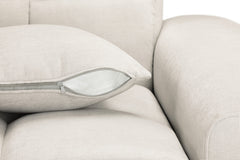 Sofa seat cushion with a zippered cover beside the upholstered arm