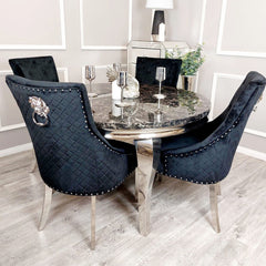 Black velvet dining chairs with diamond-quilted backs, chrome legs and decorative ring pulls