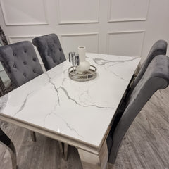 Angled view of the white marble-look tabletop and chrome legs