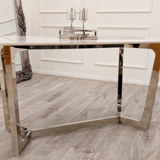 Lucien dining table with polished chrome legs and white stone top, shown from the side