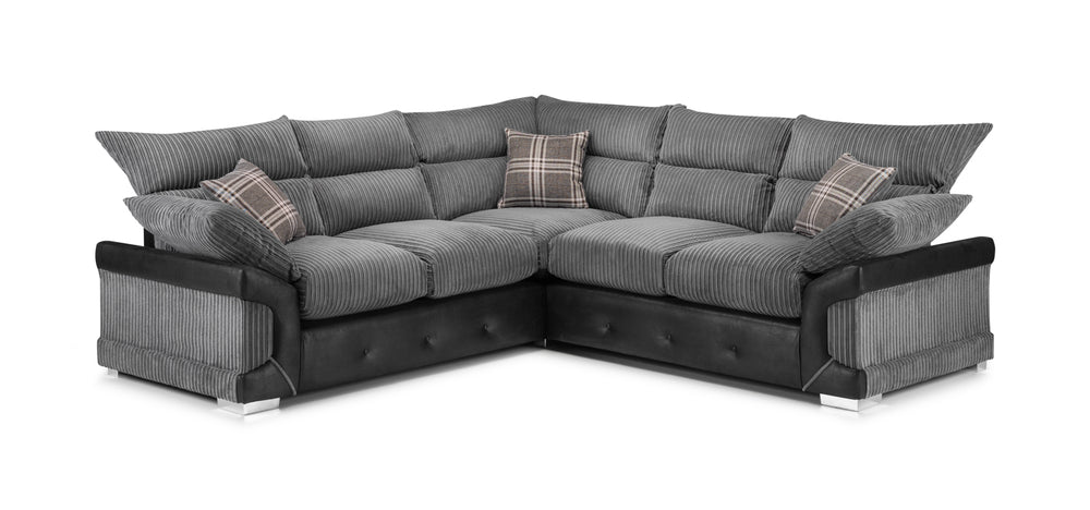Large gray corner sofa with ribbed cushions, dark base, and plaid accent pillows