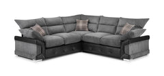 Large gray corner sofa with ribbed cushions, dark base, and plaid accent pillows