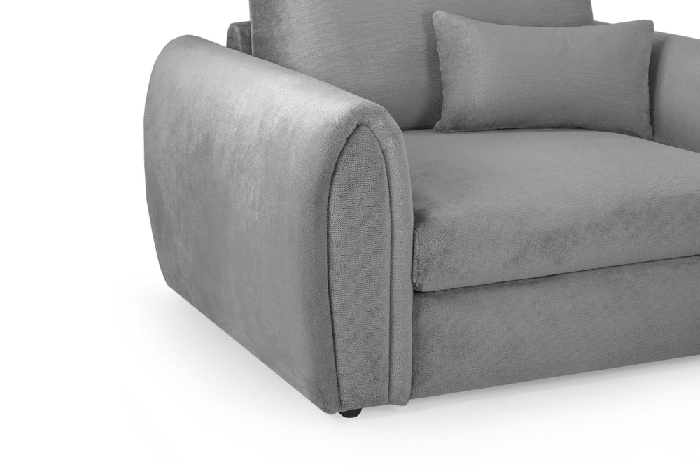 Close-up of the gray armchair's rounded upholstered arm and seat cushion
