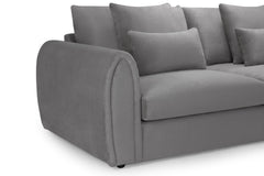 Close-up of the sofa's rounded arm, seat cushion and scatter cushions