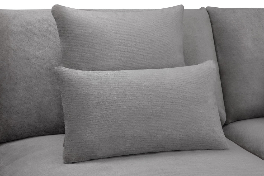 Gray scatter cushion resting against the sofa back cushions