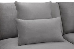 Gray scatter cushion resting against the sofa back cushions