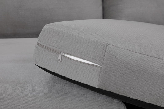 Gray sofa seat cushion with a zippered cover