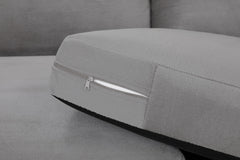 Gray sofa seat cushion with a zippered cover