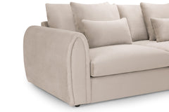 Close-up of the sofa's rounded upholstered arm, seat cushion and scatter cushions