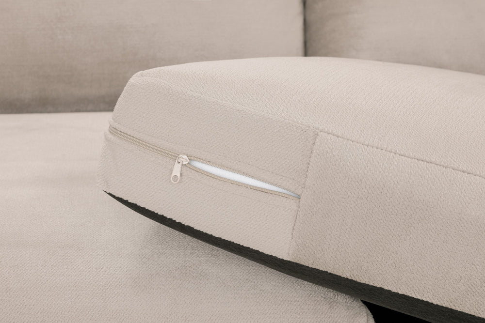 Close-up of a sofa seat cushion with a zippered cover