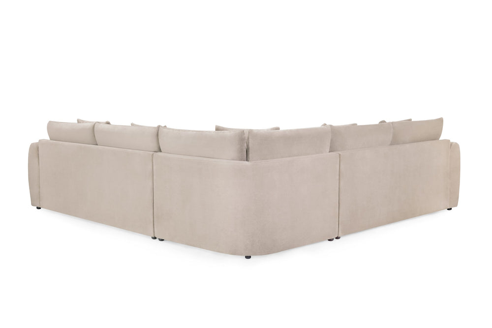 Rear view of the beige corner sofa showing its upholstered back and low feet