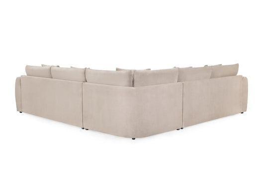 Rear view of the beige corner sofa showing its upholstered back and low feet