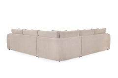 Rear view of the beige corner sofa showing its upholstered back and low feet