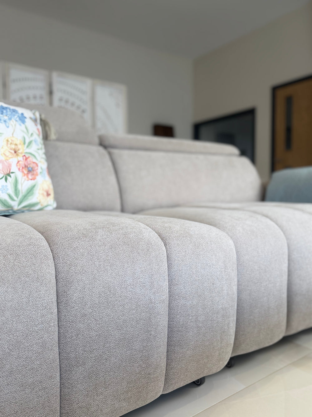 Close-up of the Molly sofa bed's textured fabric and channel-stitched seat