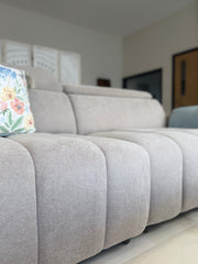 Close-up of the Molly sofa bed's textured fabric and channel-stitched seat
