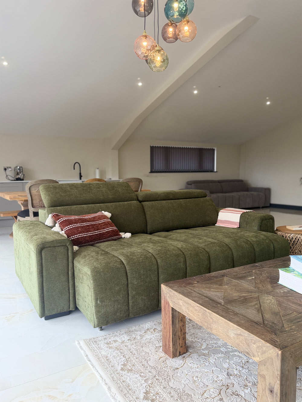 Olive three-seat electric sofa bed viewed from the front corner, with padded backrests