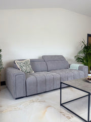 Gray three-seat sofa bed with adjustable headrests and segmented upholstery