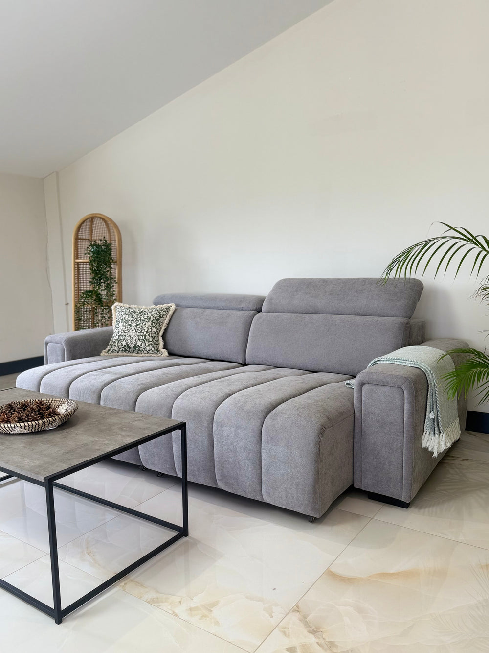 Gray electric sofa bed with extended seat sections and raised headrests