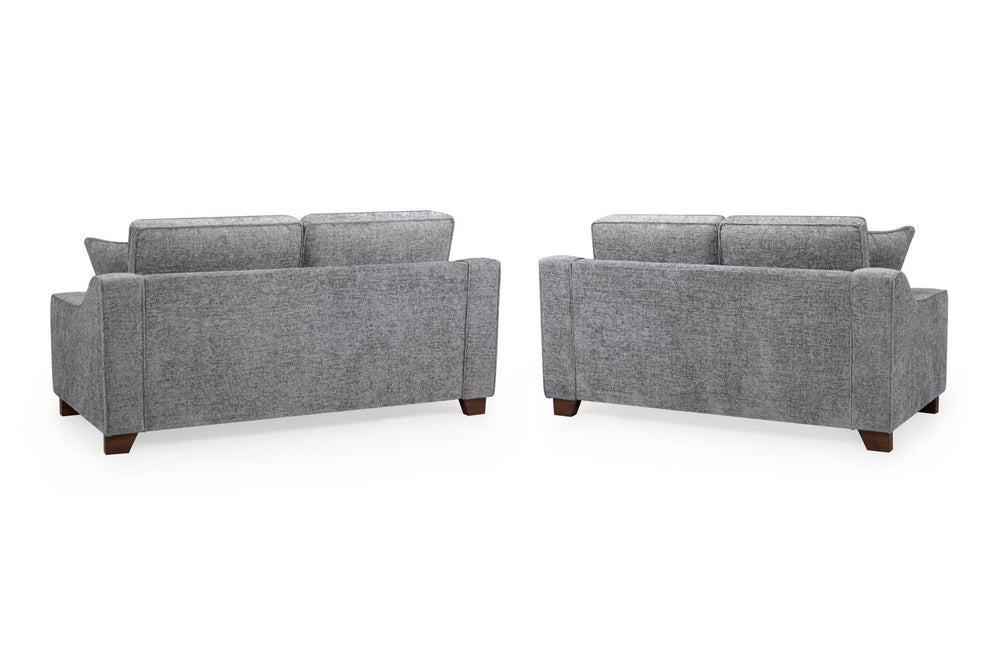 Nebraska gray sofas shown from the back with upholstered panels and dark wood feet
