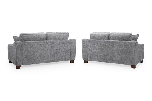 Nebraska gray sofas shown from the back with upholstered panels and dark wood feet
