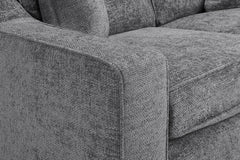 Gray woven sofa close-up showing the padded arm and seat cushion