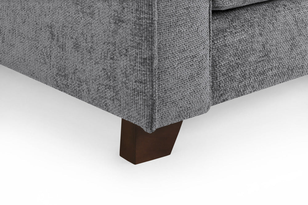 Gray sofa corner with a tapered dark wood foot