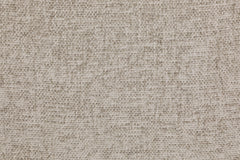 Close-up of the sofa's beige woven upholstery