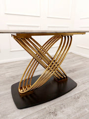 Dining table with interwoven gold supports viewed from below
