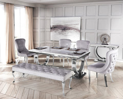 Arriana dining table with light gray top, arranged with matching chairs and bench