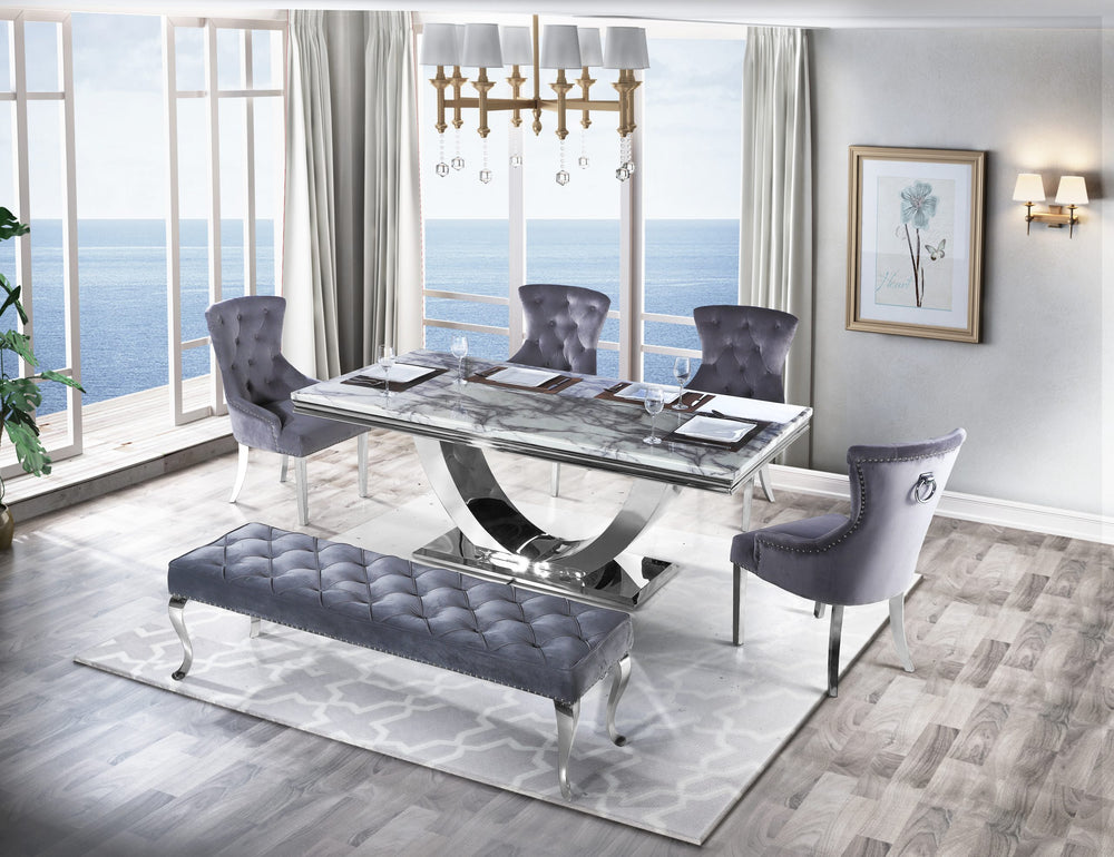 Arial dining table with gray veined top and chrome pedestal, paired with upholstered chairs and bench