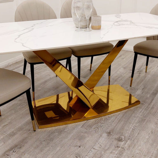 Valeo Gold 1.8 dining table showing its veined stone surface and polished gold pedestal