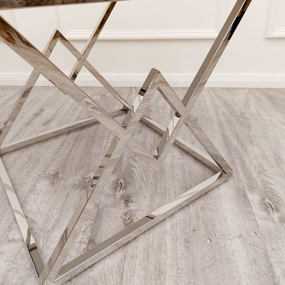 Close view of the lamp table's angular chrome base