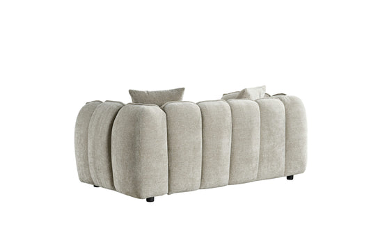 Venice two-seater sofa shown from the back, with rounded upholstered panels and short black feet