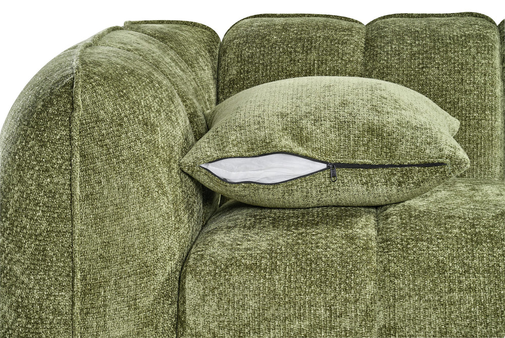 Sofa cushion with a visible zipper, beside the rounded arm and textured green upholstery