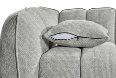 Sofa detail showing a loose cushion with a zippered cover and channel back