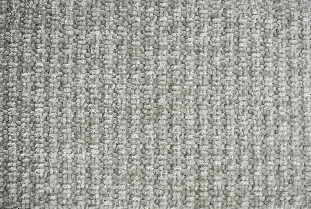 Close-up of the light gray sofa fabric's nubby woven texture