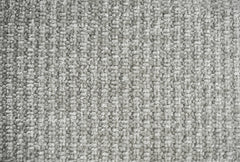 Close-up of the light gray sofa fabric's nubby woven texture