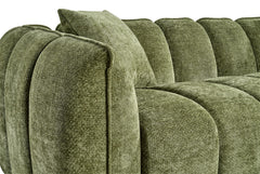 Close-up of the sofa's rounded arm, back panels, and seat cushions in textured green fabric