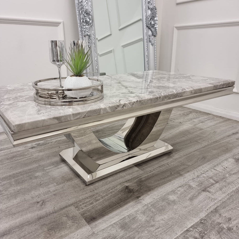 Grey marble coffee table with layered edging and a curved metal base