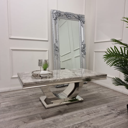 Grey marble coffee table with a reflective sculptural pedestal base