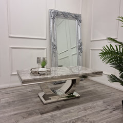 Grey marble coffee table with a reflective sculptural pedestal base