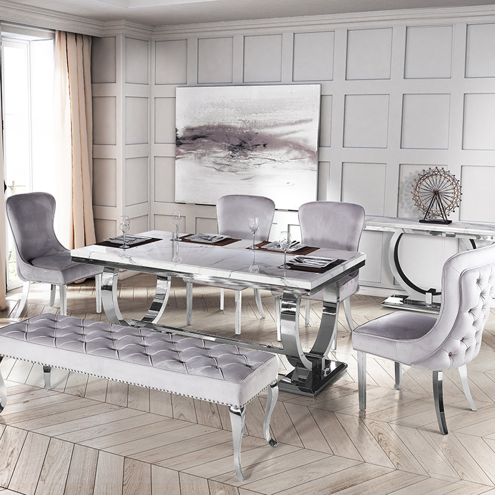 Arriana dining table with a gray veined top, loop legs, and matching upholstered bench