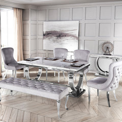 Arriana dining table with a gray veined top, loop legs, and matching upholstered bench