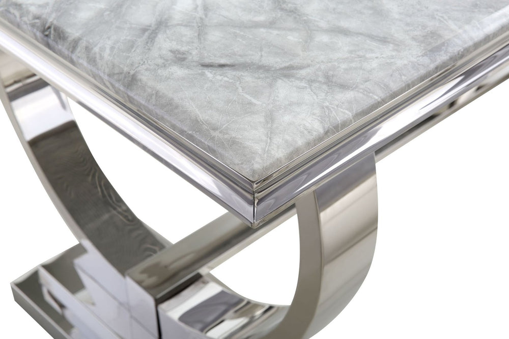 Detail of the marble tabletop edge and curved metal pedestal base