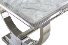 Detail of the marble tabletop edge and curved metal pedestal base